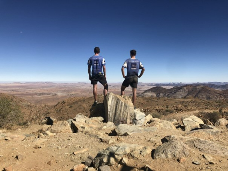Two students looking out to a landscape